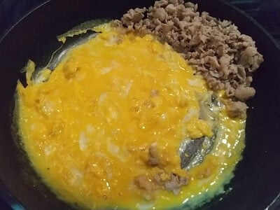 フライパンで肉を焼いて端に寄せ卵も入れ半熟になったら混ぜる