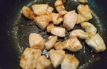 鶏むね肉に火を通して調味料を入れた写真