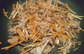 フライパンで豚肉を焼きにんじん、ごぼうも入れ調味料も入れて煮詰めた写真