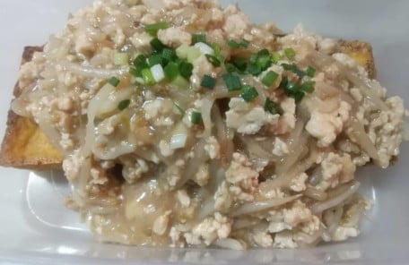 Sprinkle the green onions over the fried tofu